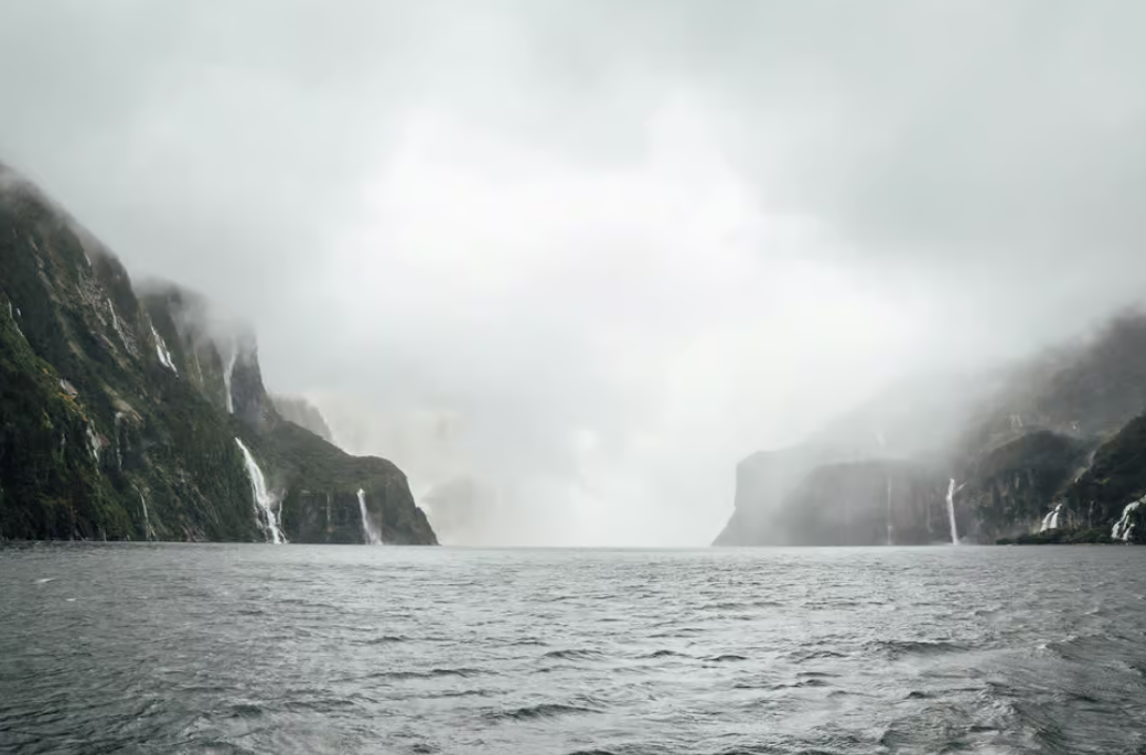 Milford Sound In The Mist With Waterfalls On The Coach And Cruise Full Day Trip Courtesy Get Your Guide